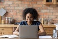 Happy Afro American remote employee working at laptop from home