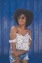 Happy afro american woman on blue background looking away Royalty Free Stock Photo