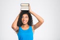 Happy afro american woman holding books on the head Royalty Free Stock Photo