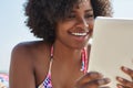 Happy afro american woman holding tablet outside Royalty Free Stock Photo