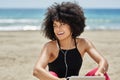 Happy afro american woman listening music on beach looking away Royalty Free Stock Photo