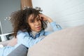 Happy afro american woman relaxing on comfortable sofa, portrait. Royalty Free Stock Photo