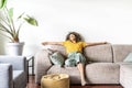 Happy afro american woman relaxing on the sofa at home Royalty Free Stock Photo