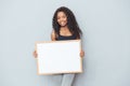 Happy afro american woman showing blank board Royalty Free Stock Photo