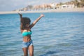 Happy afro american woman standing in water rising hands Royalty Free Stock Photo