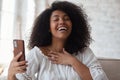 Happy afro black woman looking at mobile phone waving hand and greeting. Royalty Free Stock Photo