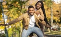 Happy afro couple having fun on date in autumn park Royalty Free Stock Photo