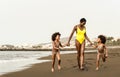 Happy Afro family having fun running on the beach during summer time