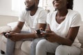 Happy afro guy and girl playing video games with joysticks Royalty Free Stock Photo