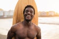 Happy afro surfer having fun surfing during sunset time - African man enjoying surf day Royalty Free Stock Photo