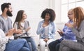 Happy afro woman appreciating support of people at rehab group meeting