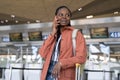 Happy afro woman talking on smartphone after first flight after covid end and arrival in airport Royalty Free Stock Photo