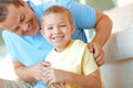 Happy afternoons spent with dad. Young boy smiling widely while his father tickles him. Royalty Free Stock Photo