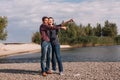 Happy age difference couple on beach on sunny windy day Royalty Free Stock Photo