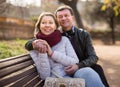 Happy aged lovers on a bench in the park Royalty Free Stock Photo