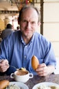 Happy aged man eating Royalty Free Stock Photo