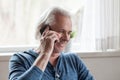 Happy aged man having funny conversation on phone Royalty Free Stock Photo