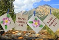 Happy Alberta Day. Holiday greeting cards with Wild rose floral symbol of Alberta province against Pyramid mountain lake Royalty Free Stock Photo