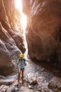 Alone woman wearing helmet for safety is engaged in active canyoning and hiking along the Saklikent Gorge in Turkey. New
