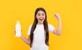 happy amazed child hold dairy beverage product. teen girl going to drink milk