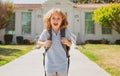 Happy amazed excited kid is going to school. Child boy with bag go to elementary school. Primary school. Pupil go study