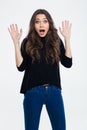 Happy amazed woman standing with raised hands