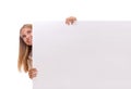 Happy amazed young girl is popping out from the side of white blank banner,isolated