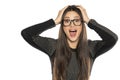 Happy amazed young woman with glasses