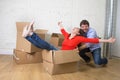 Happy American couple unpacking moving in new house playing with Royalty Free Stock Photo