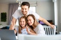 Happy american family having online meeting with relatives. Family in front of laptop monitor. Royalty Free Stock Photo