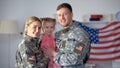 Happy american military couple with child smiling on camera, patriotic family