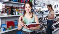 teenager buying different products in stationery shop