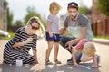 Happy amicable family with two children walking in summer. The word