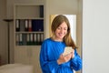 Happy or amused woman smiling as she texts a mobile message