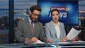Happy anchors broadcasting news in evening studio closeup. Newsreaders reporting Royalty Free Stock Photo