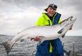 Happy angler with Baltic salmon Royalty Free Stock Photo