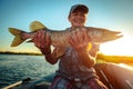 Happy angler holds pike fish Royalty Free Stock Photo