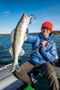 Happy angler holds Zander fish Royalty Free Stock Photo