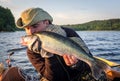 Happy angler kissing walleye fishing trophy Royalty Free Stock Photo