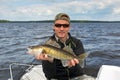 Happy angler with walleye trophy fish Royalty Free Stock Photo