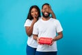 Happy black woman making romantic surprise for boyfriend giving box Royalty Free Stock Photo