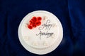 Happy anniversary White Pearl Cake or women day and valentine celebration with flowers, spoon and fork served on board isolated on
