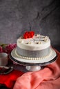 Happy anniversary White Pearl Cake or women day and valentine celebration with flowers, spoon and fork served on board isolated on