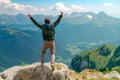 Happy anonymous man with arms raised jumping over the top of the mountain Royalty Free Stock Photo