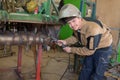 Happy apprentice welder at work in plant Royalty Free Stock Photo