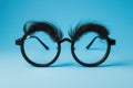 Happy april fool\'s day and funny pranks concept with a pair of comical glasses with bushy eyebrows and thick mustache