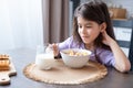 Happy arab child girl having breakfast colorful cereal with milk at home on the morning Royalty Free Stock Photo