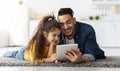 Happy Arab Dad And Little Daughter Using Digital Tablet At Home Together Royalty Free Stock Photo