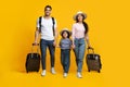 Happy Arab Family Of Three Holding Hands And Walking With Suitcases Royalty Free Stock Photo