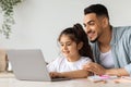 Happy arab father helping daughter with homework Royalty Free Stock Photo